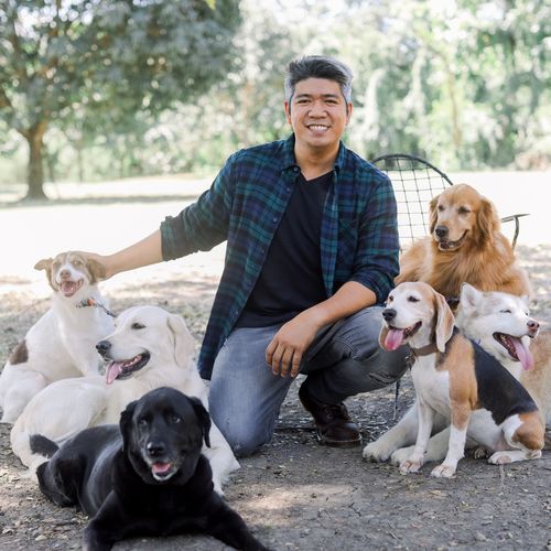 Coach Francis with a pack of dogs