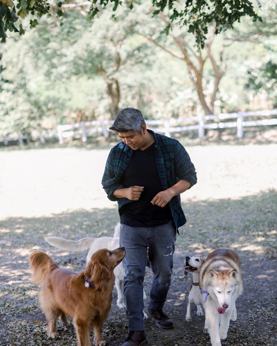 Coach Francis walking with dogs off-leash